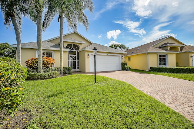 ranch-style home with a garage and a front lawn