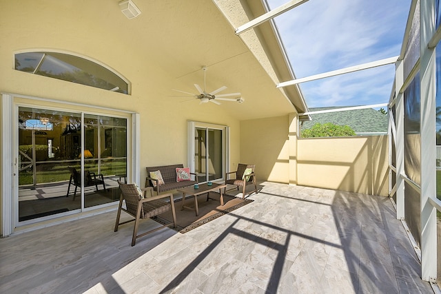 view of patio featuring glass enclosure and ceiling fan