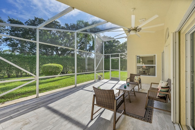 sunroom / solarium featuring ceiling fan