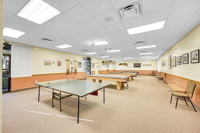 game room with a drop ceiling and light carpet