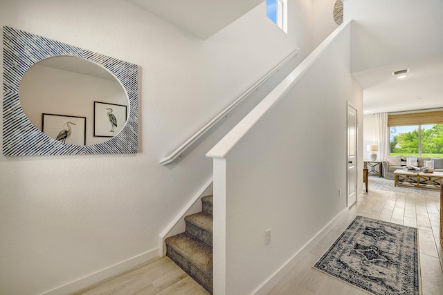 stairway with wood-type flooring