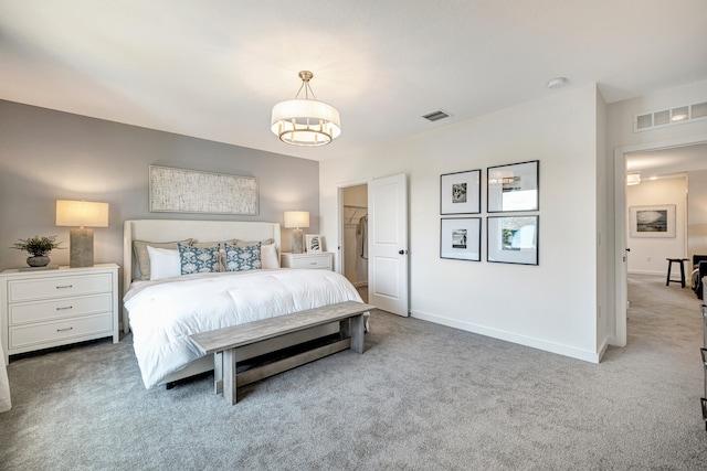 carpeted bedroom with an inviting chandelier