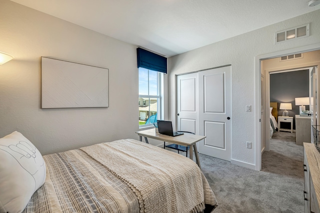 carpeted bedroom with a closet