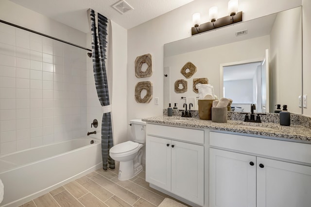 full bathroom with vanity, a textured ceiling, toilet, and shower / bathtub combination with curtain