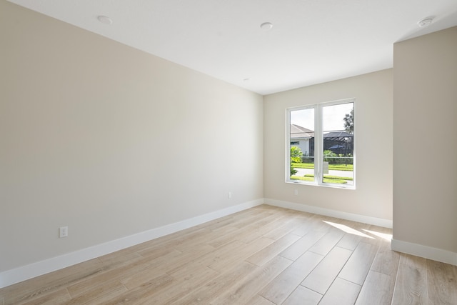 empty room with light hardwood / wood-style flooring