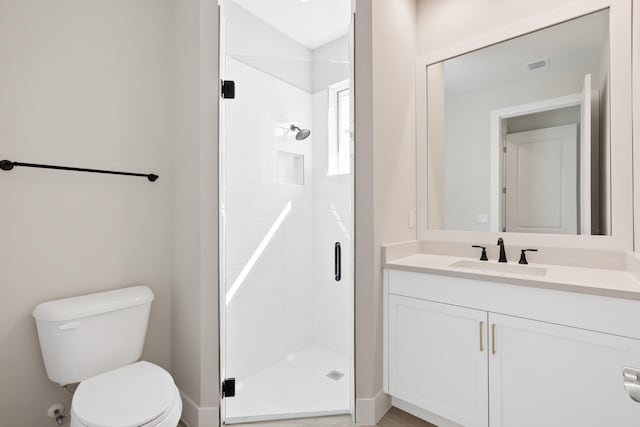 bathroom with vanity, toilet, and an enclosed shower