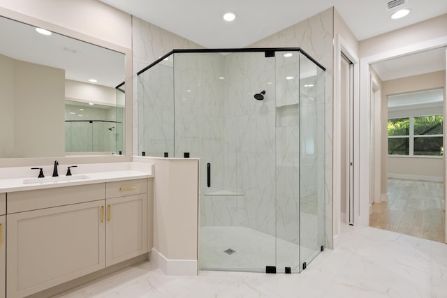 bathroom featuring vanity, walk in shower, and wood-type flooring