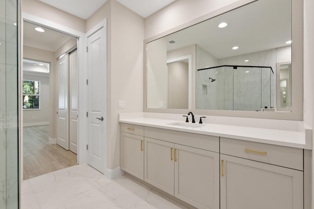 bathroom with vanity, an enclosed shower, and hardwood / wood-style flooring