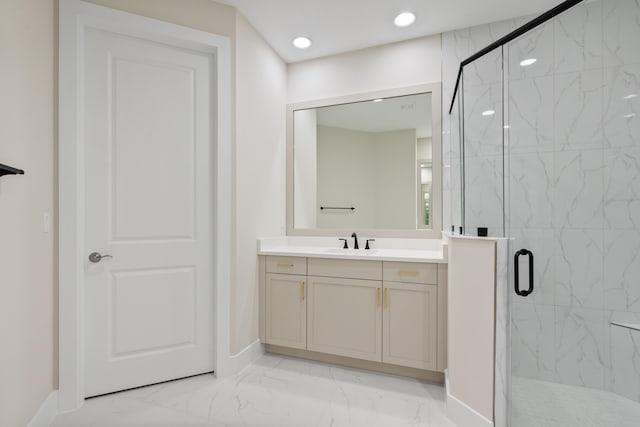 bathroom with vanity and a shower with shower door