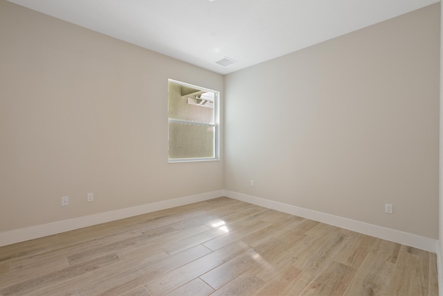 spare room featuring light hardwood / wood-style floors