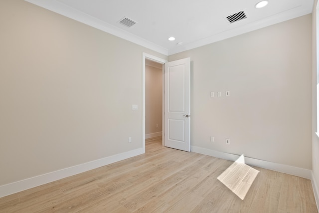 unfurnished room featuring crown molding and light hardwood / wood-style flooring