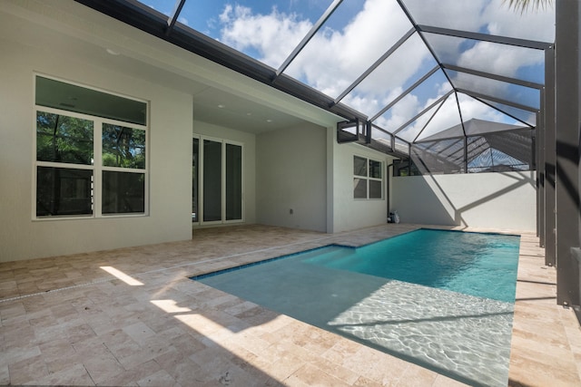 view of swimming pool with a patio and a lanai