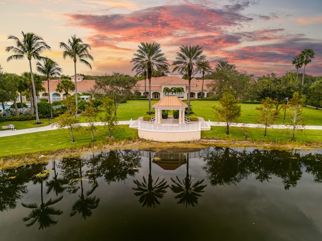 exterior space featuring a gazebo, a yard, and a water view