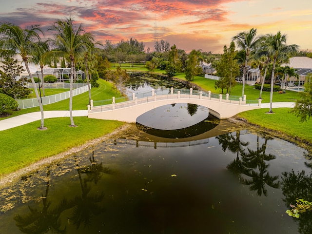 view of property's community featuring a yard and a water view