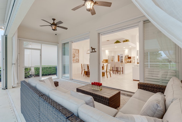 living room featuring ceiling fan and plenty of natural light