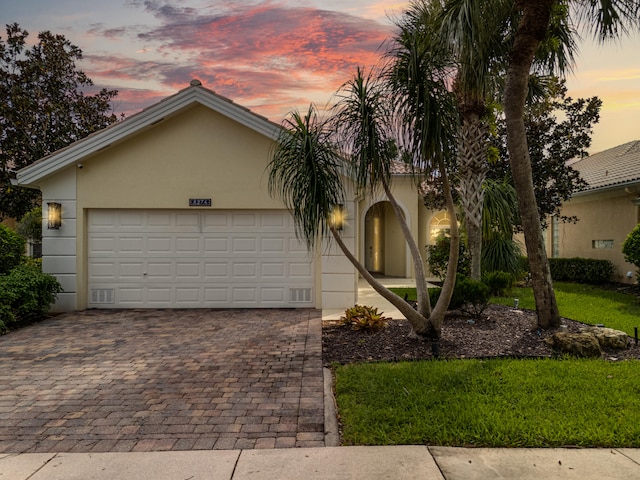 view of front facade featuring a yard and a garage