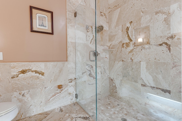 bathroom featuring toilet, tile walls, and an enclosed shower