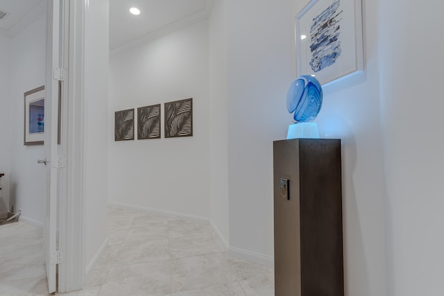 hallway featuring crown molding and light tile patterned floors