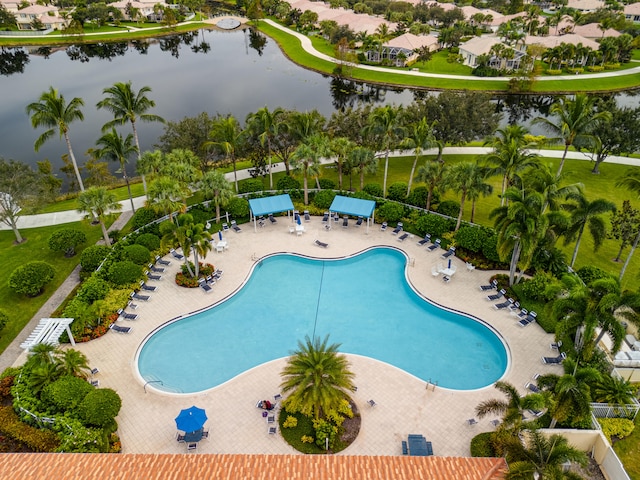 view of swimming pool featuring a water view and a patio area