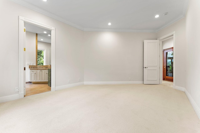 spare room with recessed lighting, ornamental molding, baseboards, and light carpet