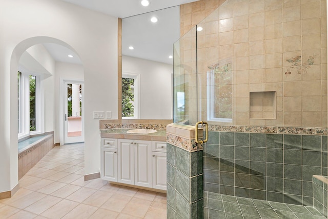 full bath featuring plenty of natural light, vanity, tile patterned floors, and a stall shower