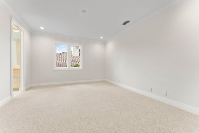 empty room featuring recessed lighting, visible vents, crown molding, baseboards, and light colored carpet