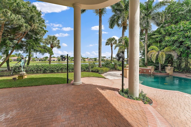 outdoor pool with a yard and a patio area