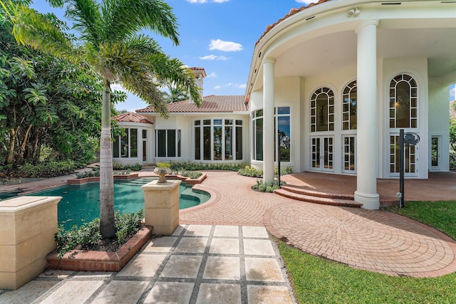 pool featuring french doors and a patio area