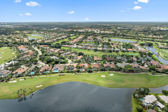 birds eye view of property featuring view of golf course, a water view, and a residential view