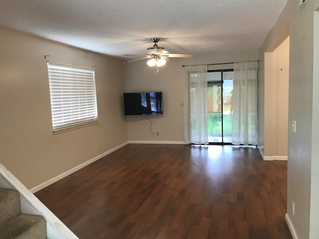 unfurnished room featuring dark hardwood / wood-style floors, a textured ceiling, and ceiling fan