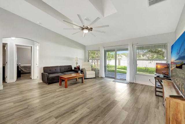 living room featuring vaulted ceiling, light hardwood / wood-style floors, and ceiling fan