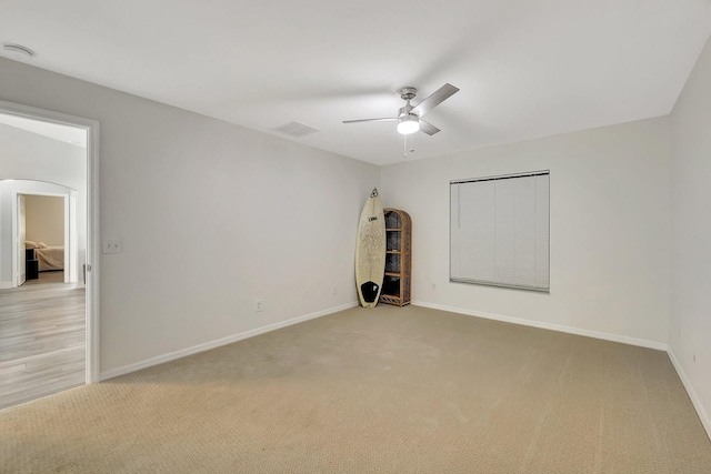 carpeted empty room with ceiling fan