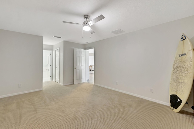 unfurnished room with light carpet and ceiling fan