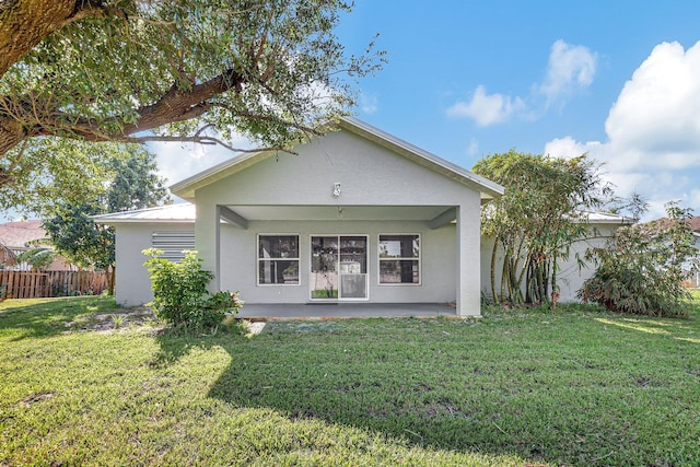 rear view of property with a patio area and a lawn