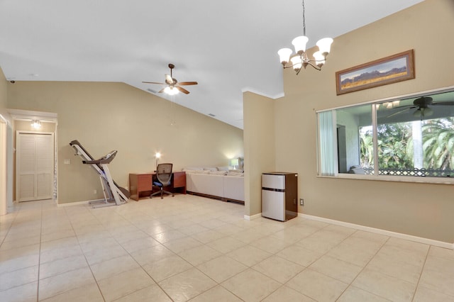 empty room featuring ceiling fan with notable chandelier, light tile patterned floors, and lofted ceiling