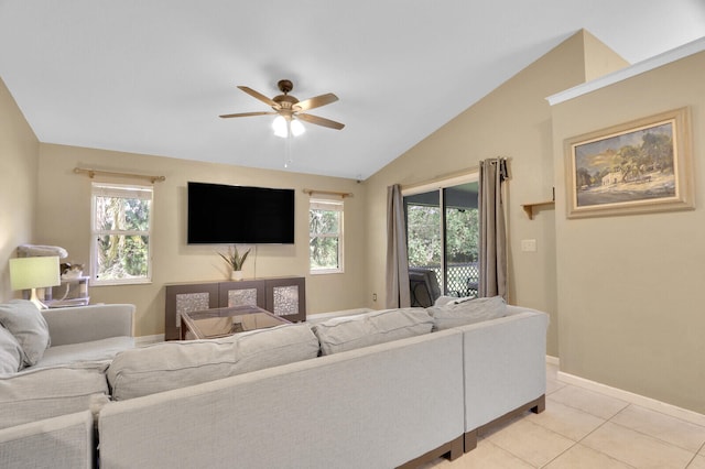 tiled living room with a wealth of natural light, ceiling fan, and lofted ceiling