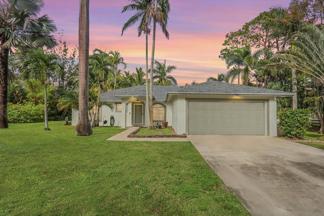 view of front of home with a lawn and a garage