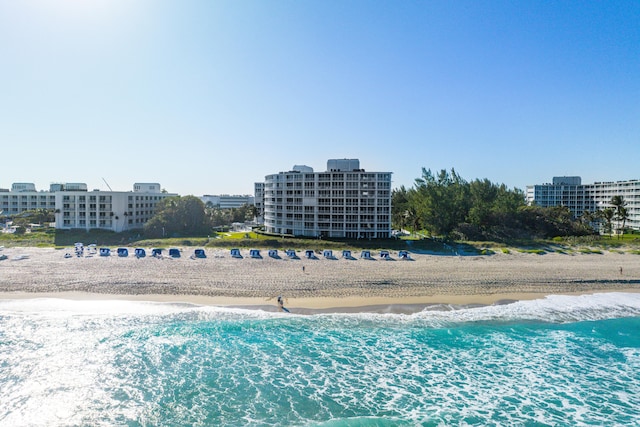 bird's eye view featuring a water view and a beach view