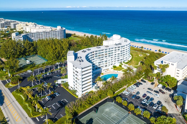 bird's eye view featuring a water view and a beach view