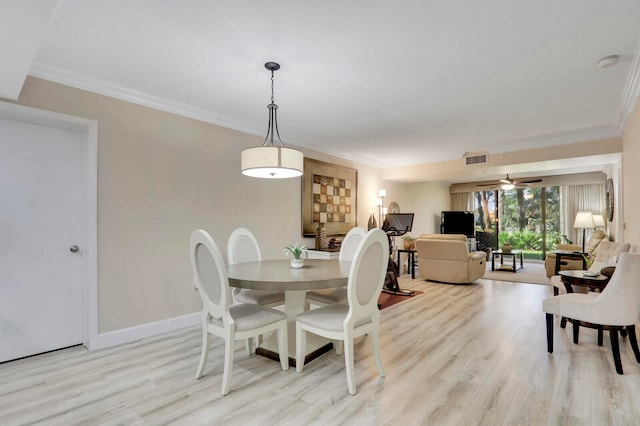 dining space with ornamental molding, light wood-type flooring, and ceiling fan