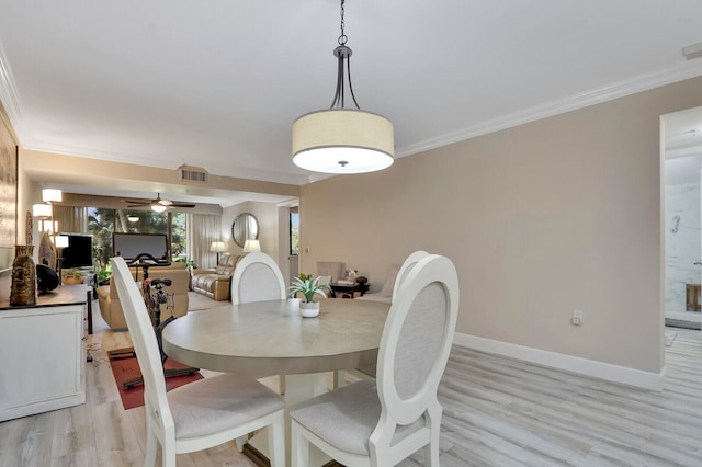 dining space with light hardwood / wood-style floors, crown molding, and ceiling fan