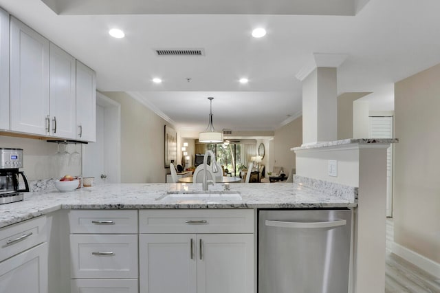 kitchen with sink, dishwasher, white cabinets, and crown molding