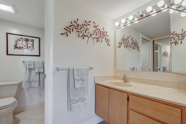 bathroom with vanity, toilet, and tile patterned floors