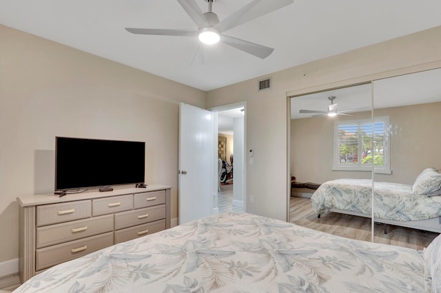 bedroom with a closet, ceiling fan, and light wood-type flooring