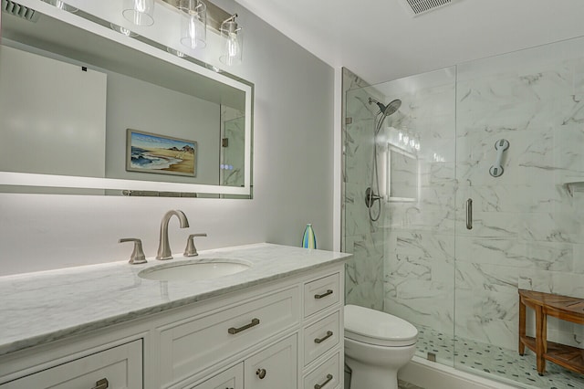 bathroom with vanity, toilet, and a shower with shower door