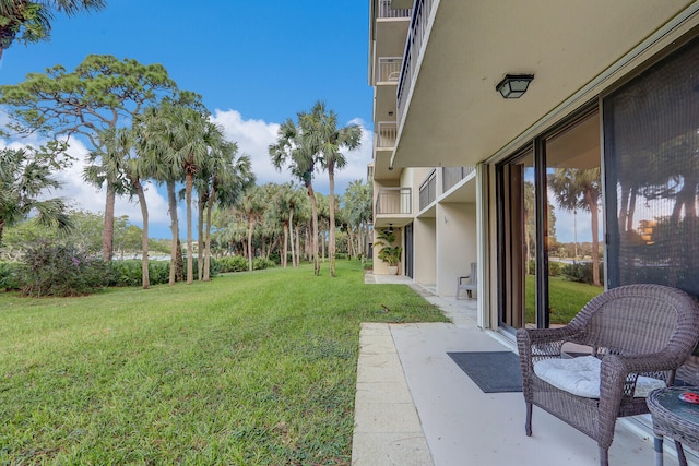 view of yard with a balcony and a patio area