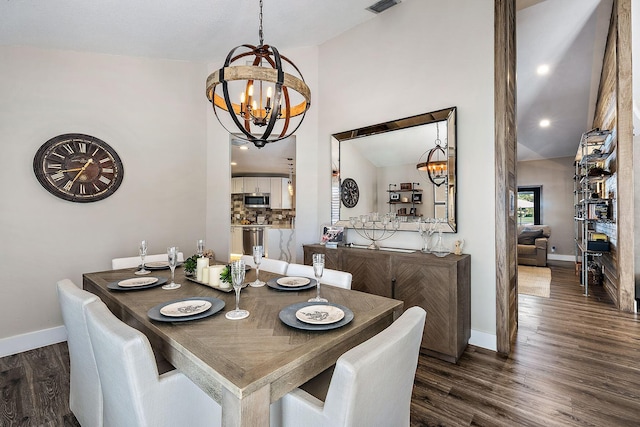 dining area featuring an inviting chandelier, baseboards, dark wood finished floors, and vaulted ceiling