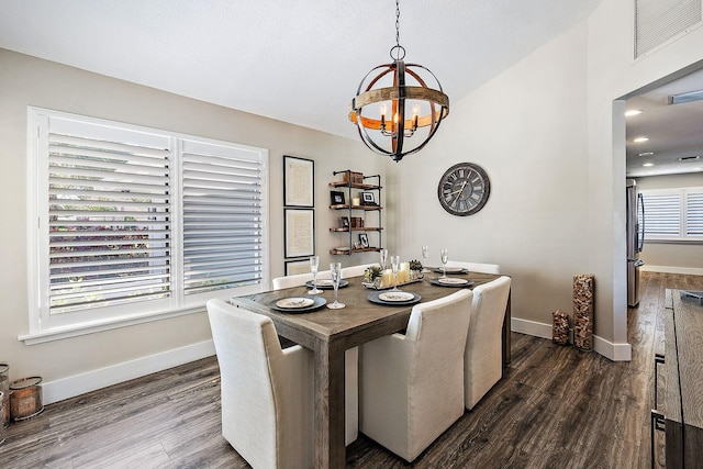 dining space featuring dark wood-type flooring and a notable chandelier