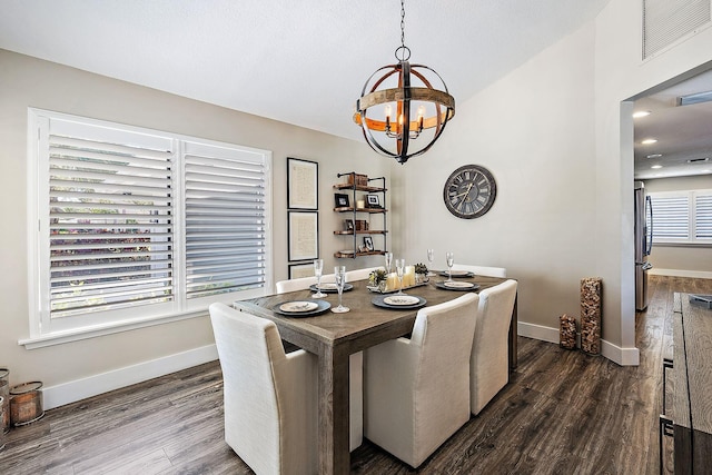 dining area with visible vents, dark wood-style flooring, baseboards, and a chandelier