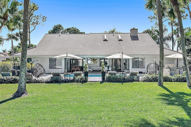 rear view of property with a patio area and a yard